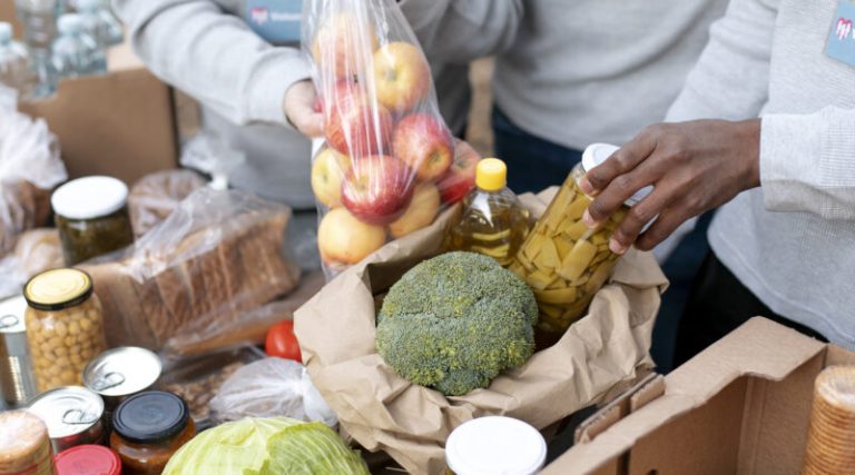 close-up-volunteers-collecting-food-dona