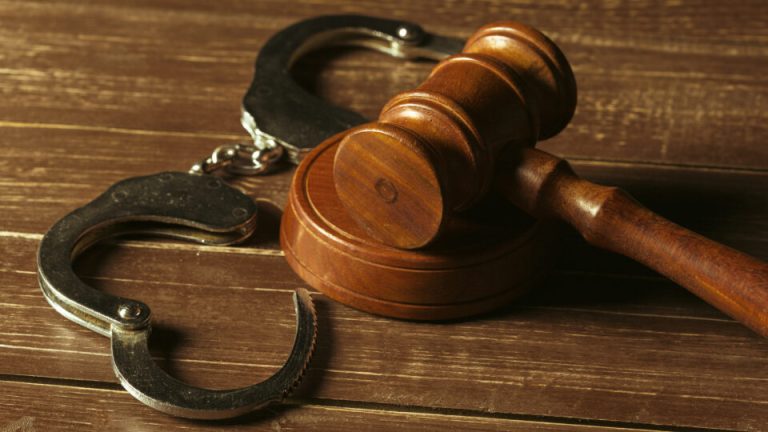 Close-up view of brown wooden mallet of judge