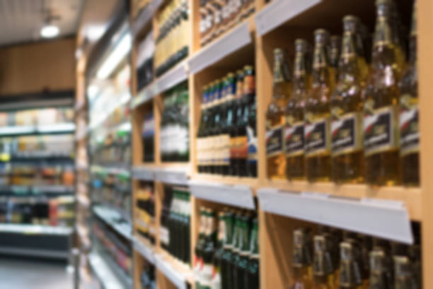 Blurred image of shelves with alcoholic drinks in supermarket